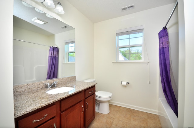 full bathroom featuring plenty of natural light, toilet, baseboards, and vanity