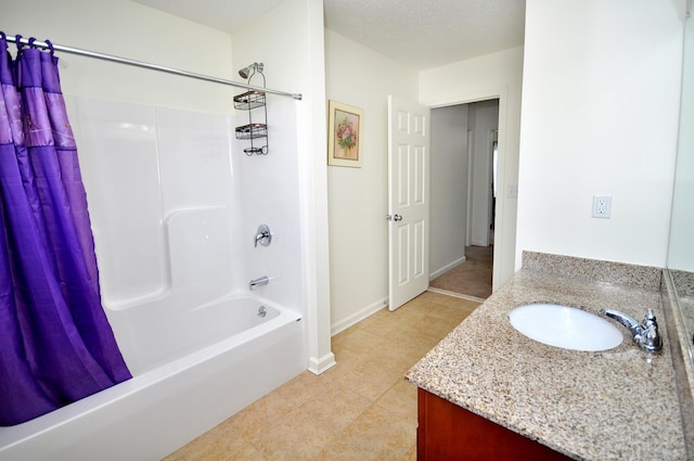 full bath featuring vanity, shower / tub combo, tile patterned flooring, and baseboards