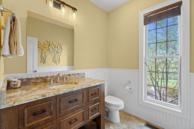 20 Peach Ln, East Lyme, CT 06333 - bathroom featuring a wainscoted wall, toilet, and vanity