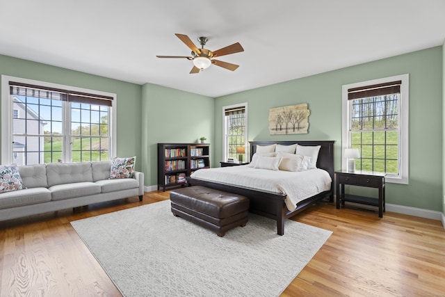 20 Peach Ln, East Lyme, CT 06333 - bedroom with multiple windows, wood finished floors, baseboards, and a ceiling fan