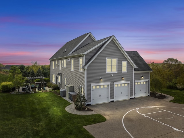 20 Peach Ln, East Lyme, CT 06333 - property exterior at dusk featuring driveway, a garage, a yard, a pergola, and roof with shingles