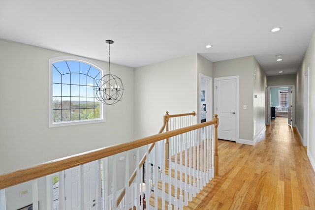 20 Peach Ln, East Lyme, CT 06333 - hallway with a chandelier, an upstairs landing, plenty of natural light, light wood-style floors, and recessed lighting