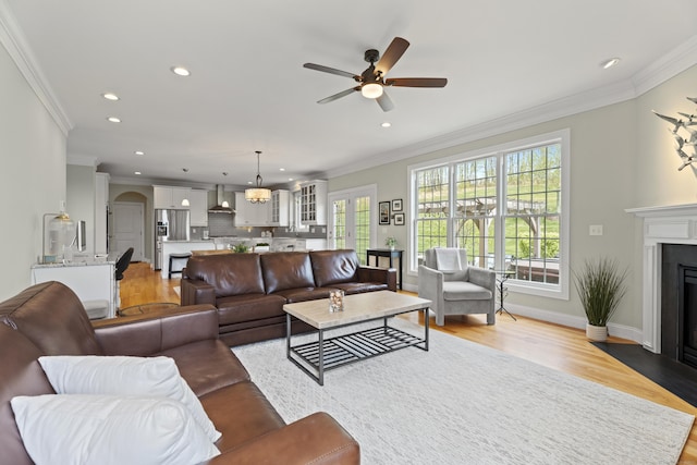 20 Peach Ln, East Lyme, CT 06333 - living room featuring ornamental molding, a fireplace with flush hearth, recessed lighting, light wood-style flooring, and ceiling fan