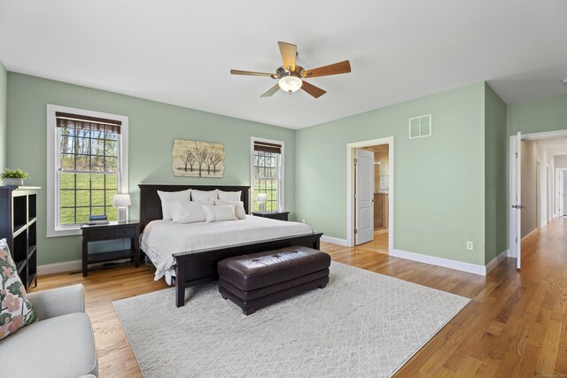 20 Peach Ln, East Lyme, CT 06333 - bedroom featuring multiple windows, baseboards, light wood-style floors, and a ceiling fan