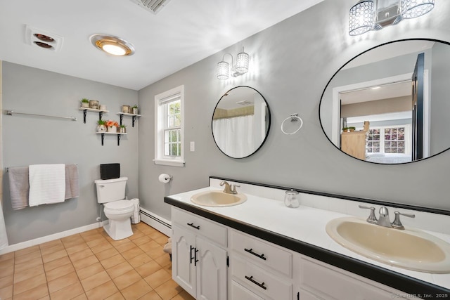bathroom featuring toilet, baseboards, a baseboard radiator, and a sink