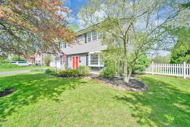 view of front of home with fence and a front yard