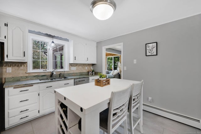 kitchen featuring a sink, tasteful backsplash, light tile patterned flooring, a baseboard radiator, and white cabinets