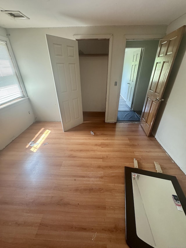 unfurnished bedroom featuring light wood-type flooring and visible vents