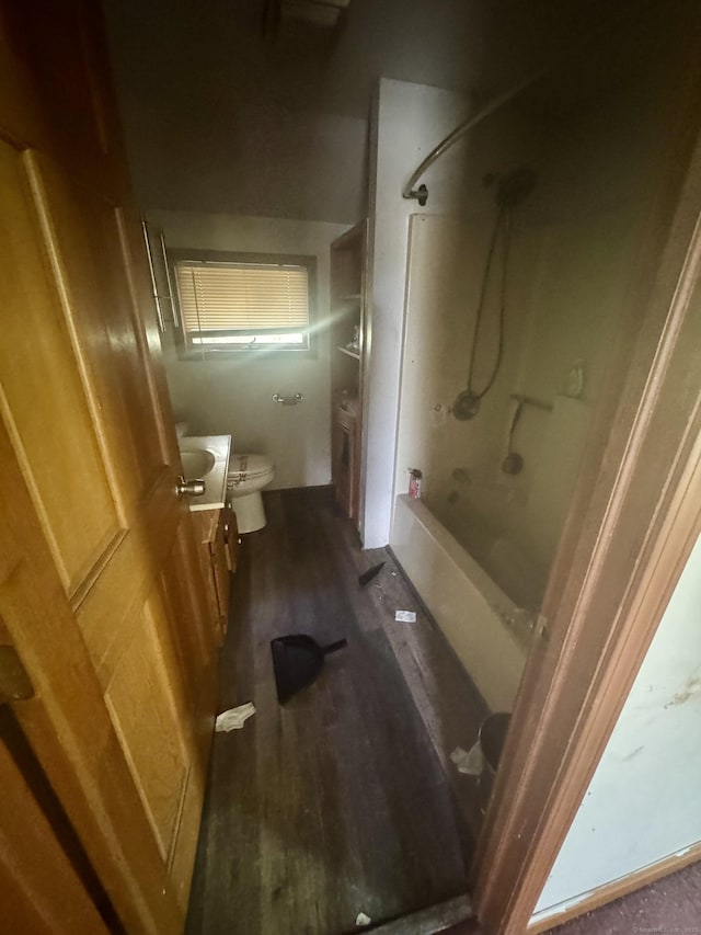 full bath with shower / bathing tub combination, vanity, toilet, and wood finished floors