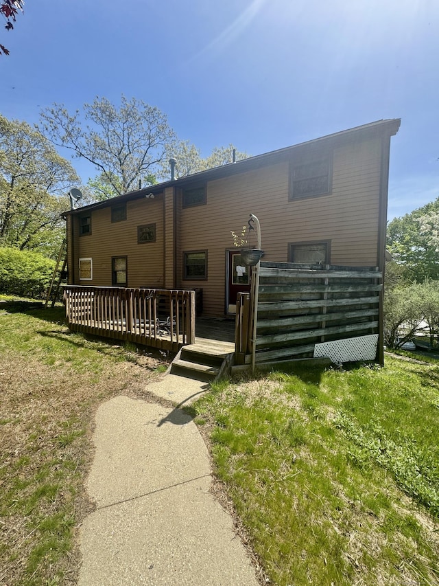 rear view of house featuring a wooden deck