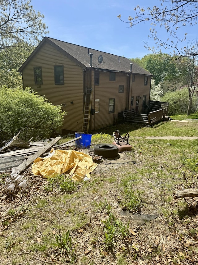 rear view of house with an outdoor fire pit