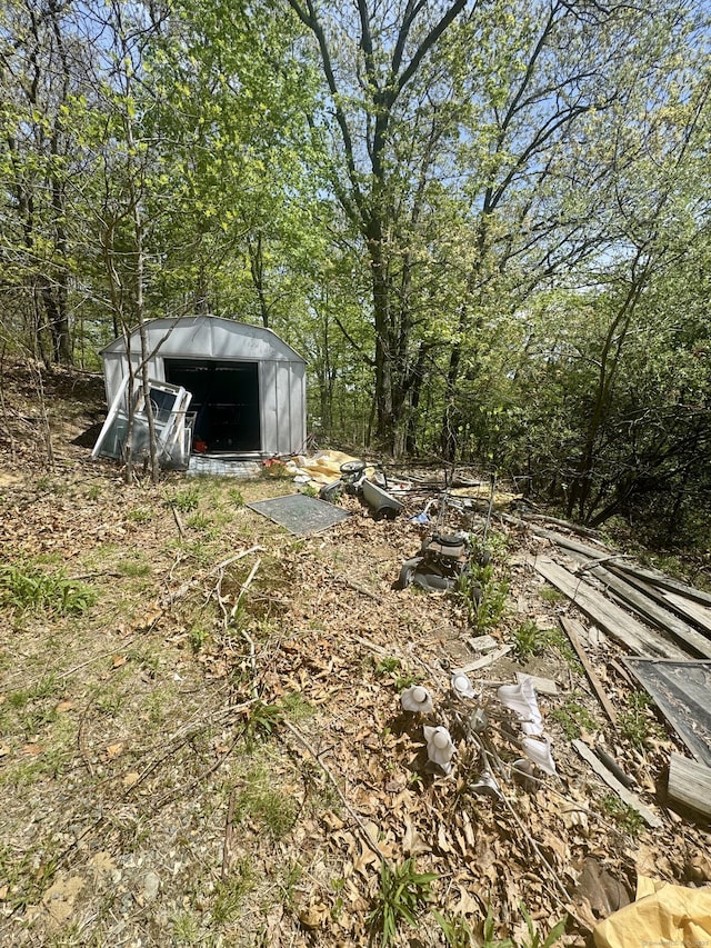 view of yard with an outbuilding and a shed