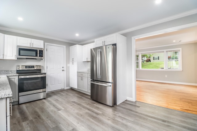 17 Alan Ave, Danbury, CT 06811 - kitchen with appliances with stainless steel finishes, light wood-style floors, crown molding, white cabinets, and light stone counters