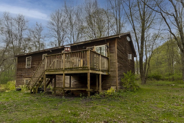 rear view of house featuring stairway and a deck