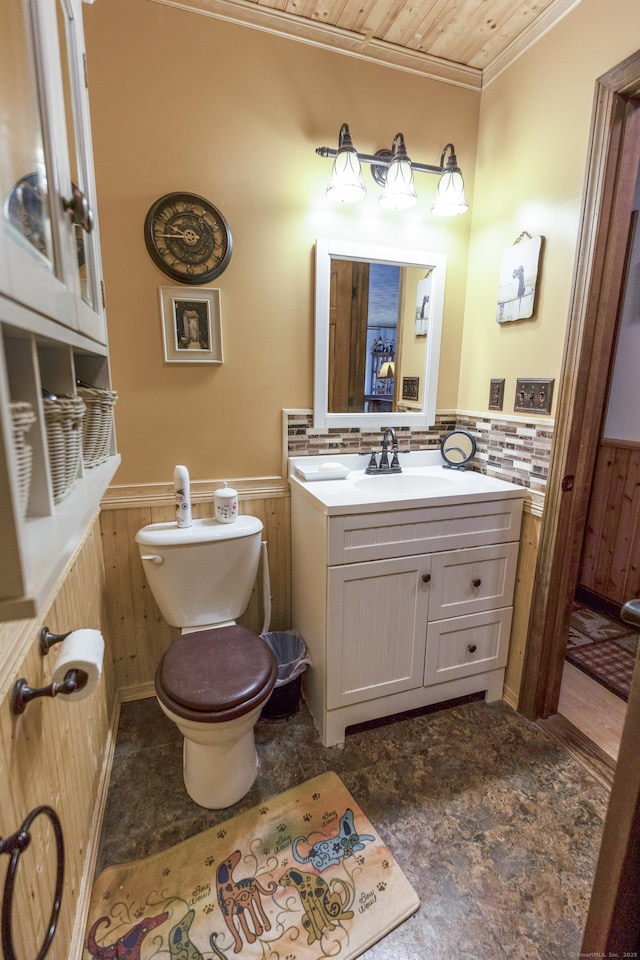 bathroom featuring wood walls, wainscoting, crown molding, and wood ceiling
