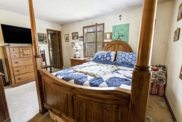 bedroom with a textured ceiling and light colored carpet