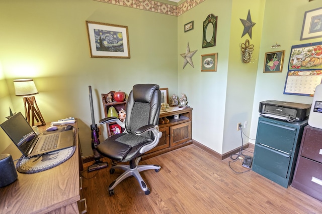 office space with baseboards and wood finished floors