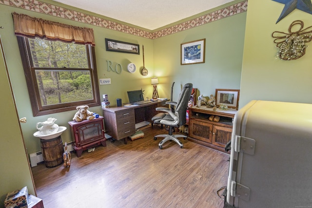 office featuring wood finished floors and baseboard heating