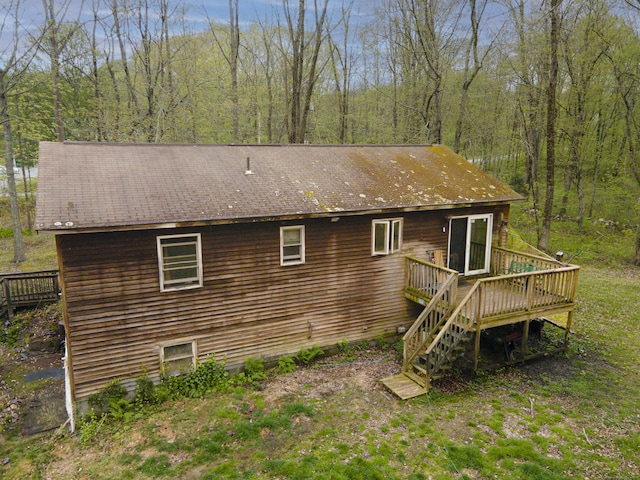 rear view of property with a deck and stairs