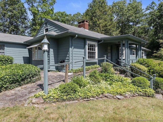 23 Pine Woods Rd, North Stonington, CT 06359 - view of front of home featuring a chimney and a porch