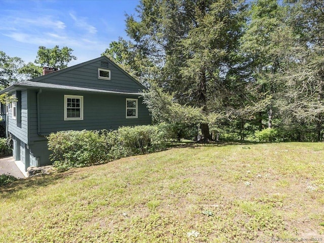 23 Pine Woods Rd, North Stonington, CT 06359 - view of property exterior featuring a chimney, a lawn, and a garage