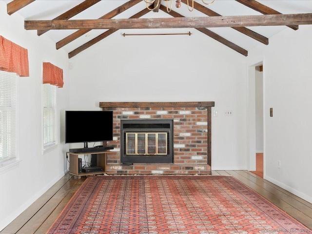 23 Pine Woods Rd, North Stonington, CT 06359 - unfurnished living room featuring wood finished floors, beam ceiling, a fireplace, and high vaulted ceiling