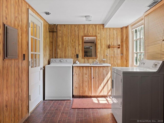 23 Pine Woods Rd, North Stonington, CT 06359 - laundry room featuring electric panel, wood walls, brick patterned floors, and washer and dryer