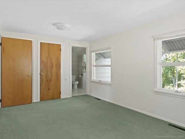 23 Pine Woods Rd, North Stonington, CT 06359 - unfurnished bedroom featuring carpet flooring, multiple closets, and ensuite bathroom