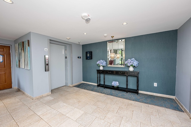 tiled entryway with recessed lighting, baseboards, and elevator