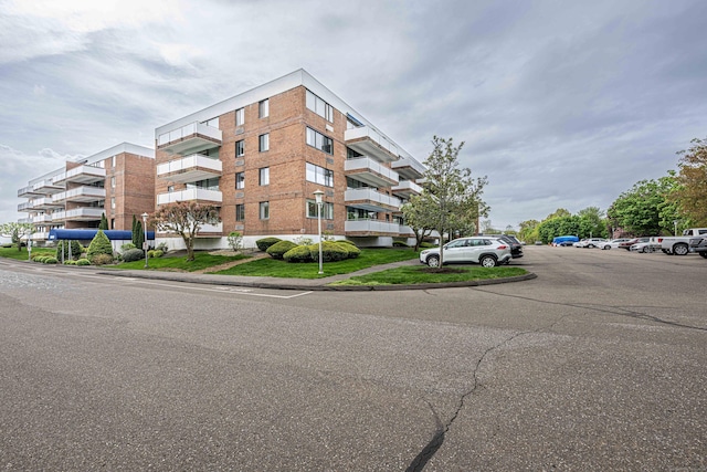 view of building exterior featuring uncovered parking