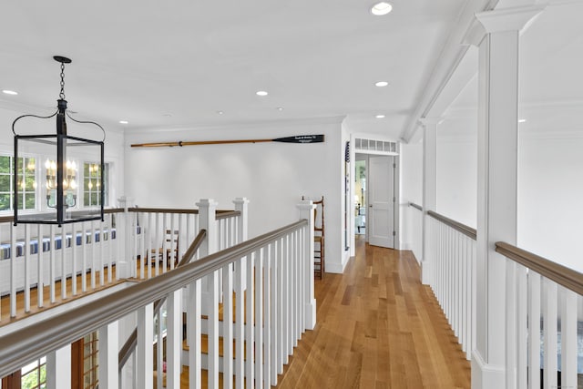250 Joshua Point Rd, Guilford, CT 06437 - corridor featuring a chandelier, light wood-style flooring, crown molding, an upstairs landing, and recessed lighting