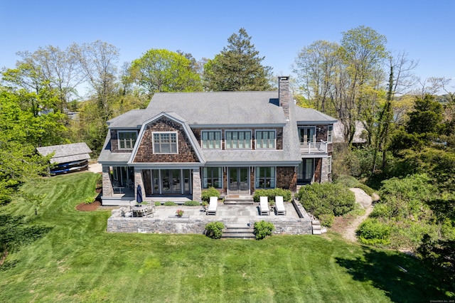250 Joshua Point Rd, Guilford, CT 06437 - rear view of house featuring french doors, a patio, a balcony, a yard, and a chimney