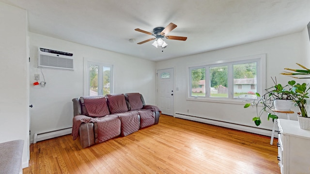 86 Butler Ave, Southington, CT 06489 - living room featuring baseboard heating, a baseboard heating unit, an AC wall unit, light wood finished floors, and a ceiling fan