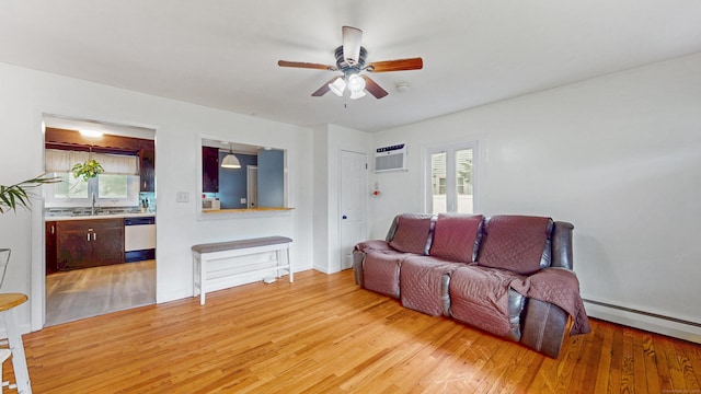 86 Butler Ave, Southington, CT 06489 - living area with light wood finished floors, a ceiling fan, a wall mounted air conditioner, and a baseboard heating unit