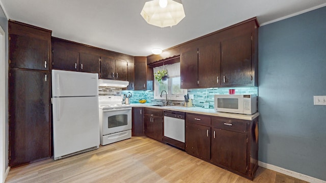 86 Butler Ave, Southington, CT 06489 - kitchen with white appliances, under cabinet range hood, tasteful backsplash, light countertops, and light wood-style floors