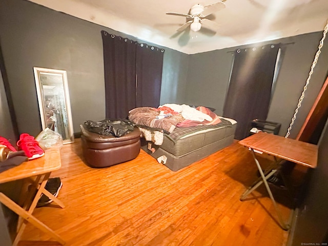 bedroom with wood finished floors and a ceiling fan
