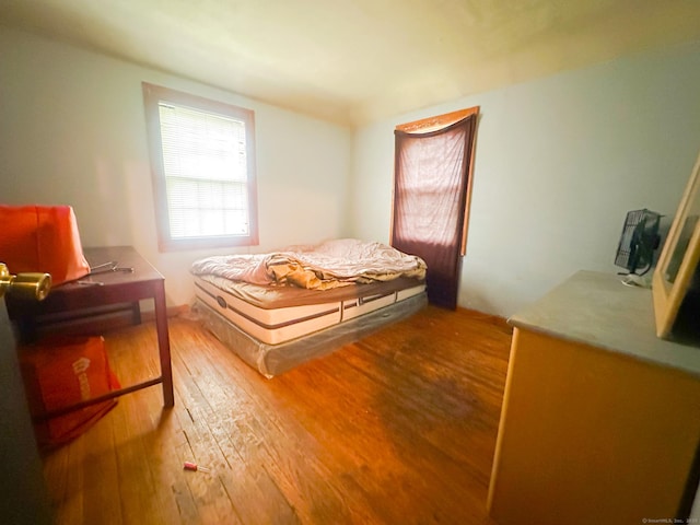bedroom with hardwood / wood-style floors