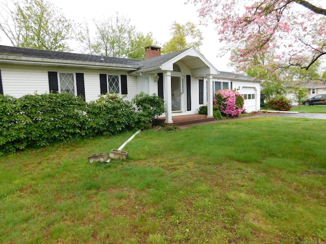 42 Riverside Dr, Branford, CT 06405 - single story home with a chimney, driveway, a front lawn, and a garage