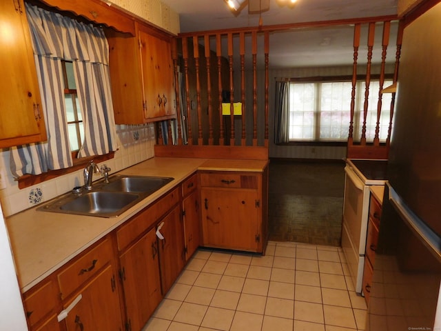 42 Riverside Dr, Branford, CT 06405 - kitchen featuring a sink, brown cabinets, light tile patterned flooring, light countertops, and white range with electric stovetop