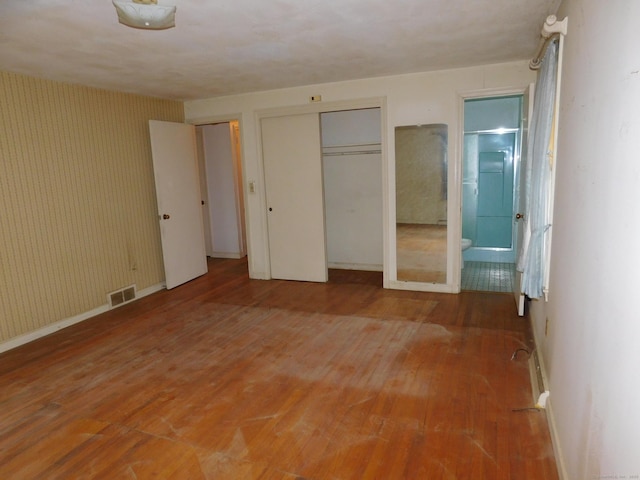 42 Riverside Dr, Branford, CT 06405 - unfurnished bedroom with a closet, baseboards, ensuite bath, visible vents, and light wood-style floors