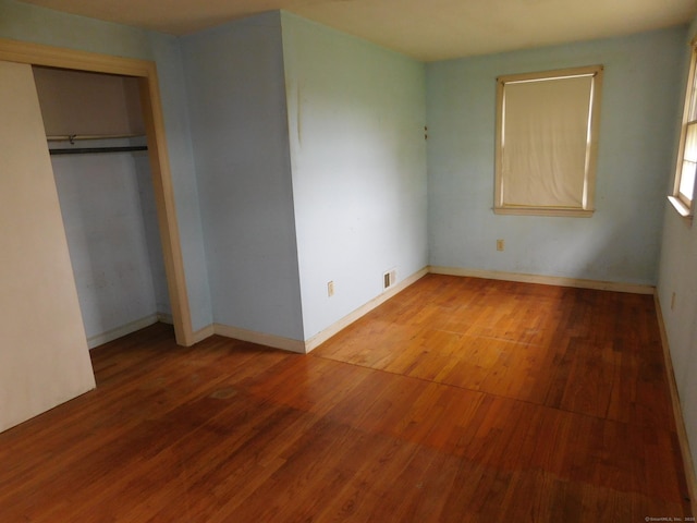 42 Riverside Dr, Branford, CT 06405 - unfurnished bedroom with a closet, baseboards, visible vents, and wood finished floors