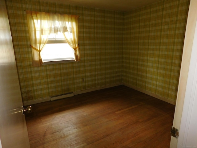 42 Riverside Dr, Branford, CT 06405 - spare room featuring a baseboard radiator, baseboards, wallpapered walls, and wood finished floors
