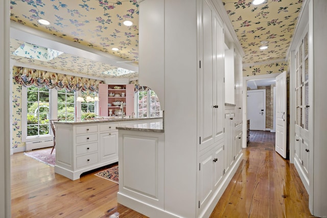 173 Highwoods Dr, Guilford, CT 06437 - corridor featuring a baseboard radiator, light wood-type flooring, ornamental molding, and wallpapered walls
