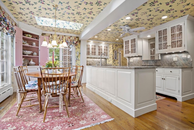 173 Highwoods Dr, Guilford, CT 06437 - dining room featuring a chandelier, light wood-type flooring, a skylight, crown molding, and recessed lighting