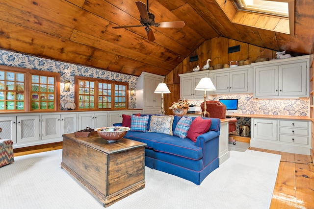 173 Highwoods Dr, Guilford, CT 06437 - living room featuring wallpapered walls, vaulted ceiling, light wood-style floors, wooden ceiling, and ceiling fan