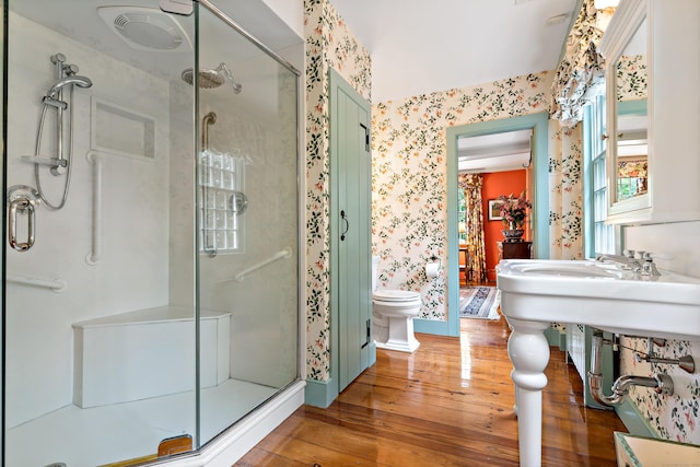 173 Highwoods Dr, Guilford, CT 06437 - bathroom with wallpapered walls, wood-type flooring, a shower stall, and toilet