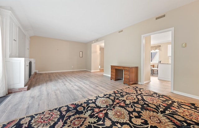 unfurnished living room featuring light wood-style flooring and baseboards
