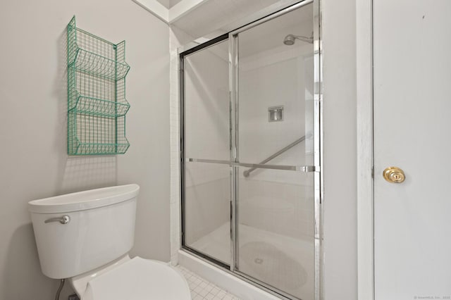 full bathroom with a stall shower and toilet