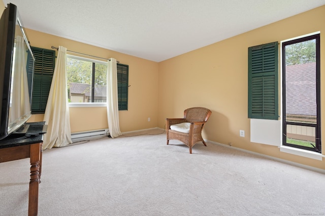 unfurnished room with carpet, a baseboard heating unit, and baseboards