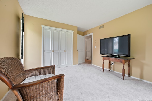 living area with light colored carpet and baseboards